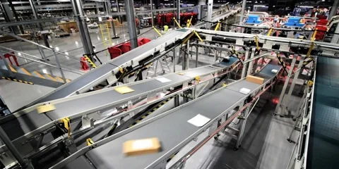 Parcel sorting conveyors in a postal operation
